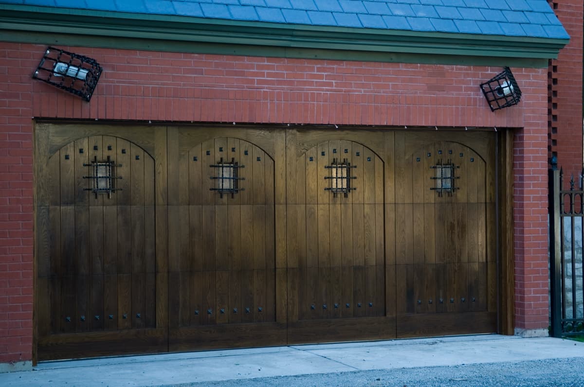 Wooden carriage-style garage doors with iron trim
