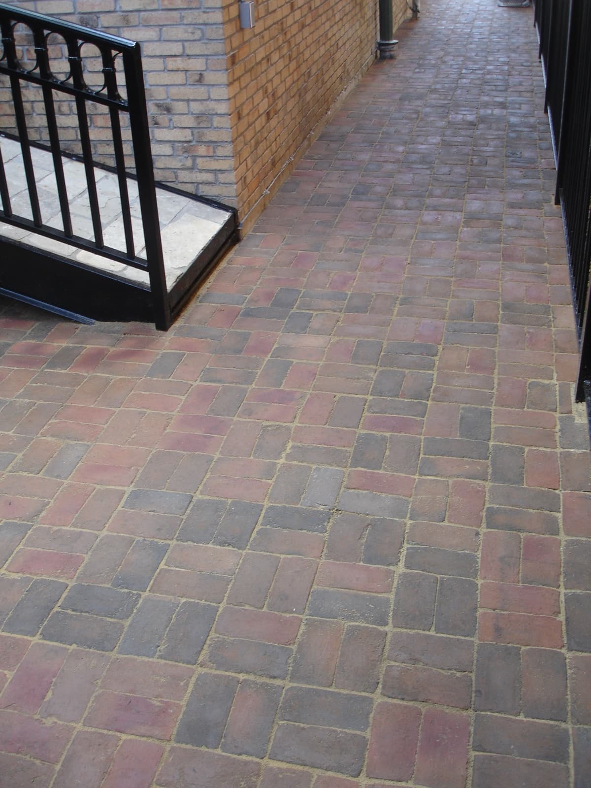 Paver walkway along a brick home addition