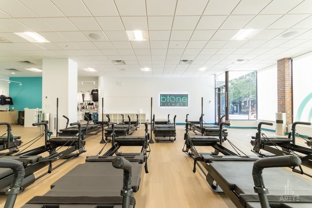 Fitness studio with rows of reformer machines