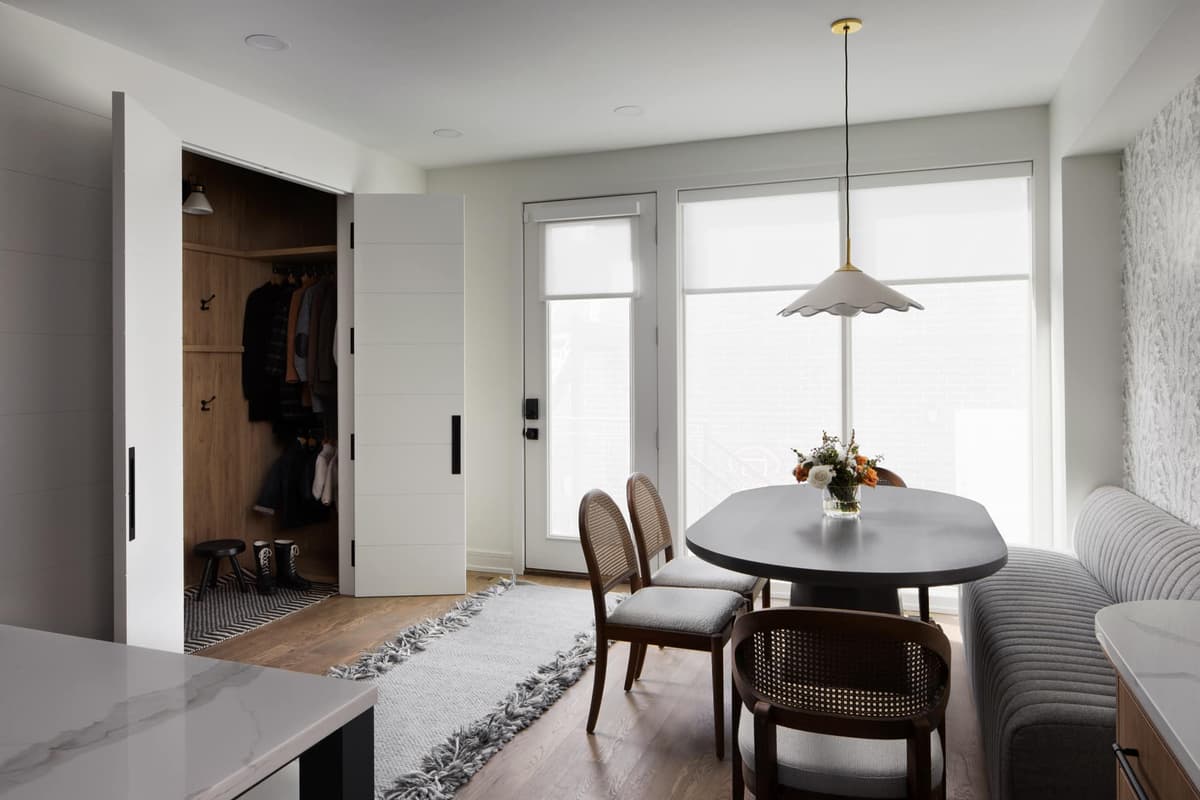 Dining nook with a pendant light and a banquette