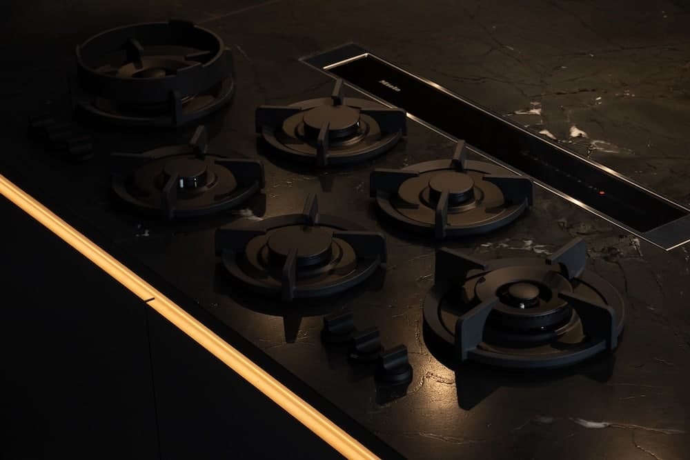 Black cooktop on a dark stone counter