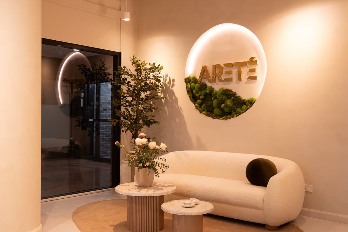Areté Lakeshore East Design Studio lounge with the lit Areté sign