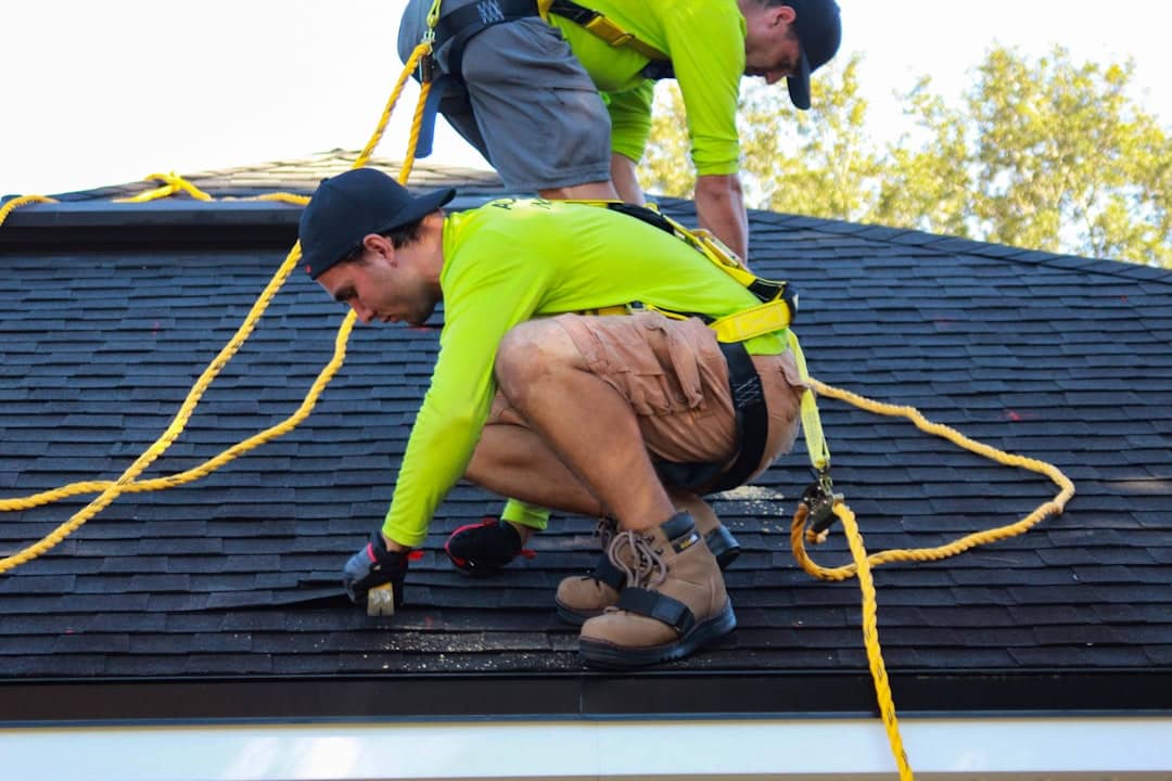 A professional roofing crew installing shingles